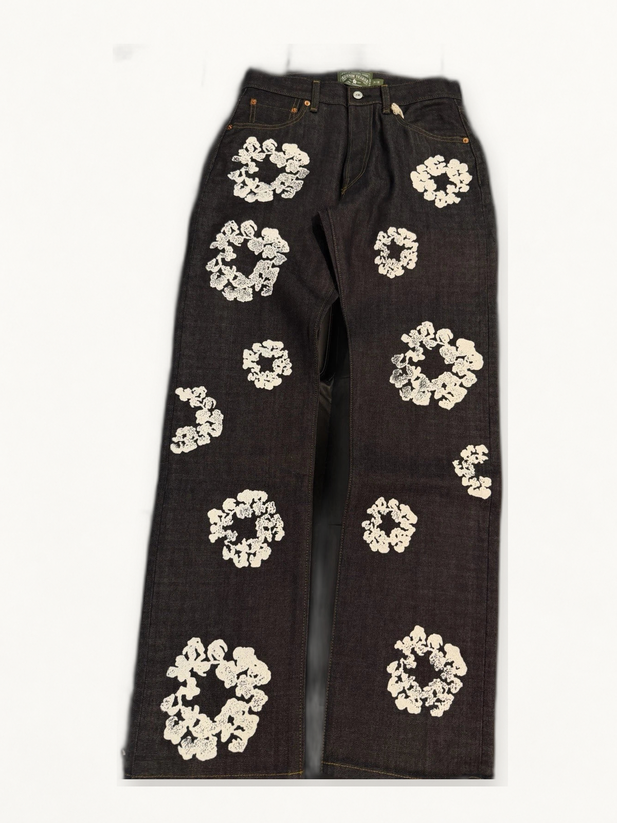 Denim Tears dark wash cotton wreath jeans on warm off white studio background