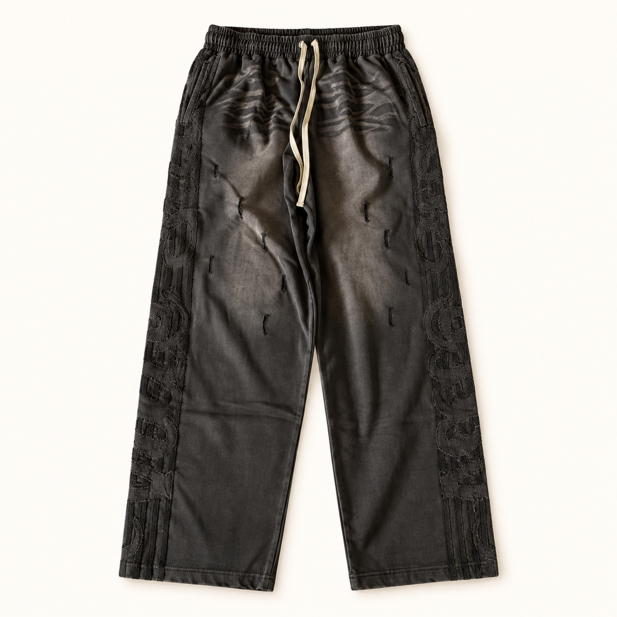 Black Vale Lives Valley Track sweatpants on a warm off-white studio background
