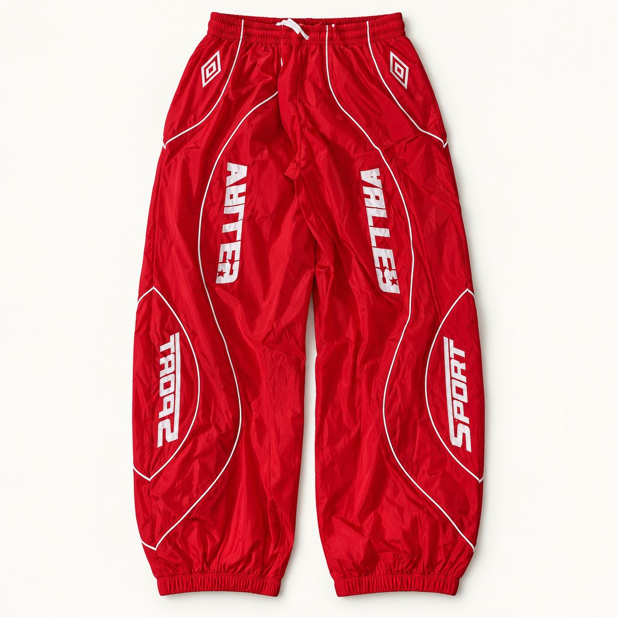 Red Vale Lives Valley Track sweatpants on warm off-white studio background