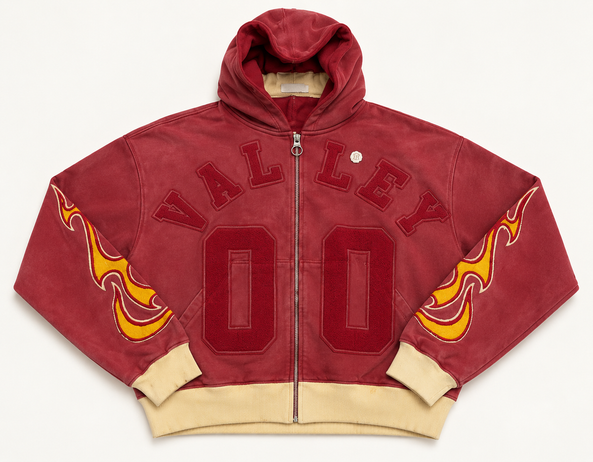 Vale Forever red flame zip-up hoodie on a warm off-white studio background
