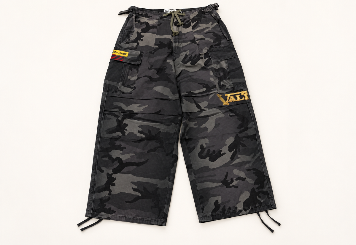 Vale VA-1 black camouflage cargo sweatpants on warm off-white studio background